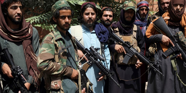 Taliban fighters pose for photograph in Kabul on Aug. 18, 2021. (AP Photo/Rahmat Gul)