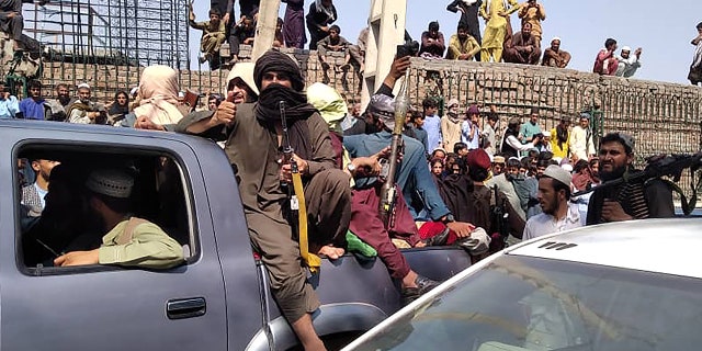 Taliban fighters sit on a vehicle on the street in Jalalabad on August 15, 2021. (Getty Images)