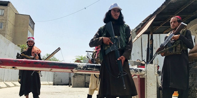Taliban fighters stand guard at a checkpoint near the US embassy that was previously manned by American troops, in Kabul, Afghanistan, Tuesday, Aug. 17, 2021. 