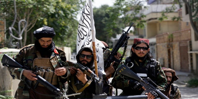 Taliban fighters display their flag on patrol in Kabul, Afghanistan, on Thursday. (AP Photo/Rahmat Gul)