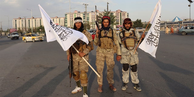 Taliban fighters hold Taliban flags in Kabul, Afghanistan, Monday, Aug. 30, 2021. (AP Photo/Khwaja Tawfiq Sediqi)