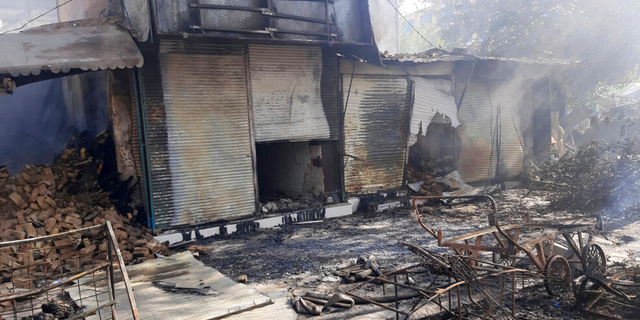 Smoke rises from damaged stores after fighting between the Taliban and Afghan security forces in the northern Afghan town of Kunduz on Sunday, August 8, 2021.