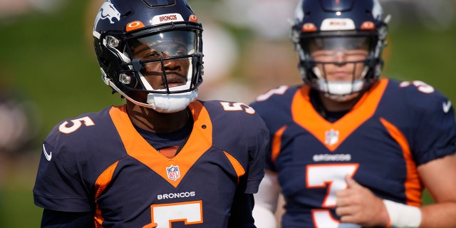 Denver Broncos quarterbacks Teddy Bridgewater, front, and Drew Lock take part in drills during an NFL football training camp at the team's headquarters Tuesday, Aug. 17, 2021, in Englewood, Colo. (AP Photo/David Zalubowski)