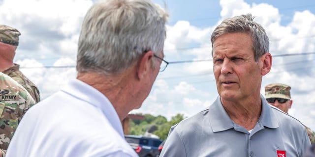 Gov. Bill Lee, right, greets officials upon arriving in Waverly, Tenn., Sunday, Aug. 22, 2021, to inspect flood damage in the area. (Alan Poizner/The Tennessean via AP, Pool)