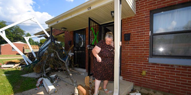 Annie Rushing steps off her porch after it flooded forcing her into a shelter, Monday, Aug. 23, 2021, in Waverly, Tenn. Heavy rains caused flooding in Middle Tennessee days ago and have resulted in multiple deaths, and missing people as homes and rural roads were also washed away. 