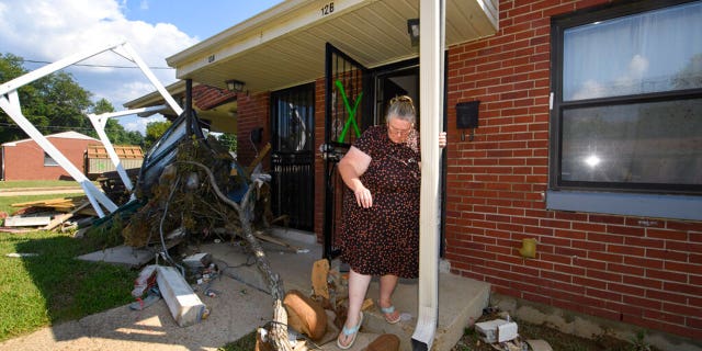 Annie Rushing steps off her porch after it flooded forcing her into a shelter, Monday, Aug. 23, 2021, in Waverly, Tenn. Heavy rains caused flooding in Middle Tennessee days ago and have resulted in multiple deaths, and missing people as homes and rural roads were also washed away. 