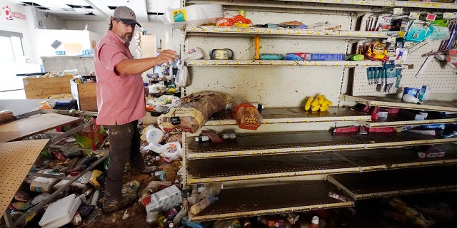 John Curtis, co-owner of Waverly Cash Saver grocery store, walks through his damaged store Sunday, Aug. 22, 2021, in Waverly, Tenn. Heavy rains caused flooding in Middle Tennessee and have resulted in multiple deaths as homes and rural roads were washed away. Curtis' store is the only grocery store in town. 