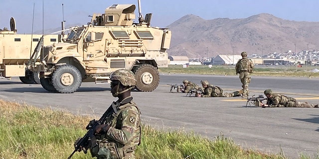 U.S soldiers stand guard along a perimeter at the international airport in Kabul, Afghanistan.