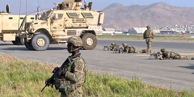 U.S soldiers stand guard along a perimeter at the international airport in Kabul, Afghanistan