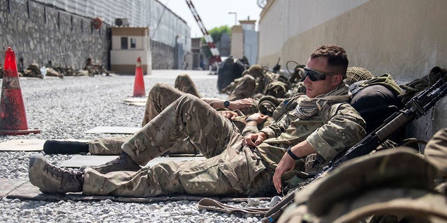In this photo issued by Britain's Ministry of Defence (MoD), showing members of UK Armed Forces who are working to evacuate entitled personnel from Afghanistan's Kabul airport, Monday Aug. 23, 2021.  Defence Secretary Ben Wallace has said the Kabul evacuation effort is "down to hours now, not weeks" as he conceded Britain's involvement will end when the US leaves Afghanistan.  (LPhot Ben Shread/MoD via AP)