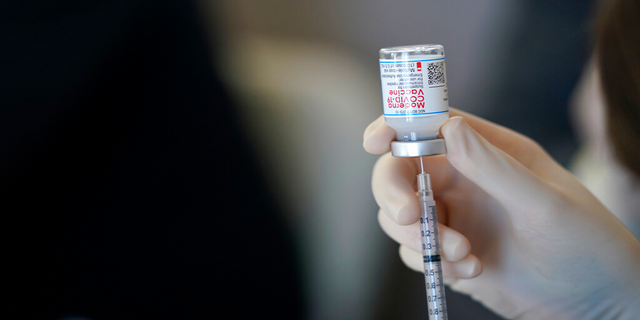 FILE: A worker readies syringes with the Moderna COVID-19 vaccine in Metairie, La.