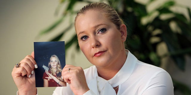 Virginia Roberts Giuffre holds a photo of herself at age 16, when she says Palm Beach multimillionaire Jeffrey Epstein began abusing her sexually.