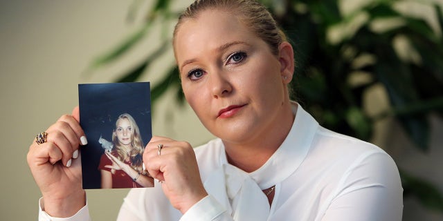 Virginia Giuffre holds a photo of herself at age 16, when she said Palm Beach multimillionaire Jeffrey Epstein began abusing her sexually.