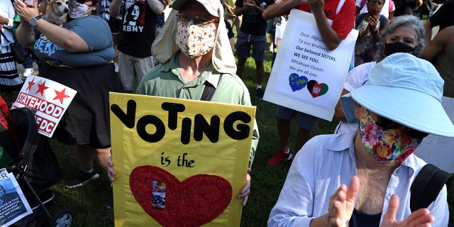 WASHINGTON, DC - AUGUST 28: Voting rights activists participate in a pre-march rally during a March On For Voting Rights event at McPherson Square August 28, 2021 in Washington, DC. Activists gathered in Washington to mark the 58th anniversary of the 1963 March On Washington, where Dr. Martin Luther King delivered his "I Have a Dream" speech, and urged the Senate to pass voting rights legislations. (Photo by Alex Wong/Getty Images)