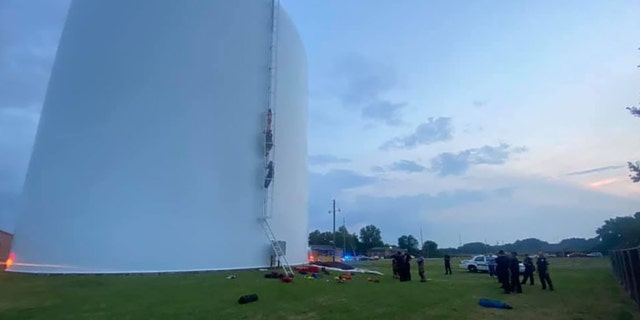 Firefighters rescued a woman Thursday who was found swimming in a 70-foot high water tank in Athens, Alabama
