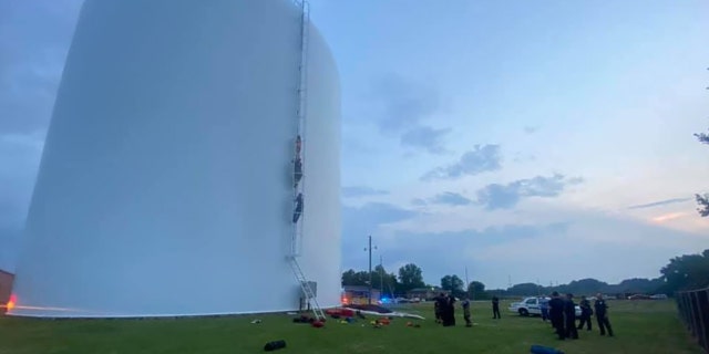 Firefighters rescued a woman Thursday who was found swimming in a 70-foot high water tank in Athens, Alabama