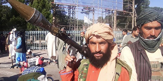 A Taliban fighter holds a rocket-propelled grenade along the roadside in Herat, Afghanistan's third biggest city, on Friday. (Photo by AFP via Getty Images)