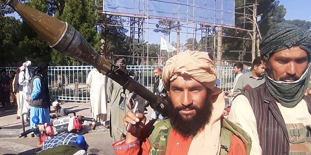 On Friday, a Taliban fighter holds a rocket-propelled grenade along the road in Herat, Afghanistan's third-largest city. (AFP photo via Getty Images)