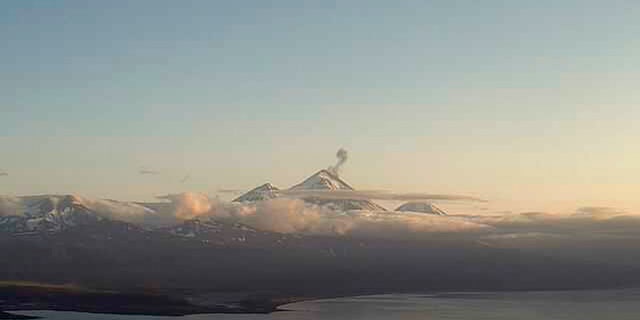 In this webcam image provided by the Alaska Volcano Observatory, is the Pavlof Volcano in a state of eruption with episodic low-level ash emissions on Thursday, Aug. 5, 2021. Three remote Alaska volcanos are each in a state of eruption, one producing lava and the other two blowing steam and ash. So far, no small communities near any of the three have been impacted, Chris Waythomas, a geologist with the Alaska Volcano Observatory, said Thursday. (Alaska Volcano Observatory via AP)