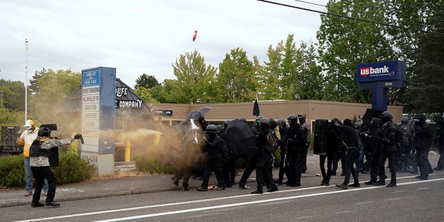 Members of the far-right Proud Boys clash with counter-protesters during rival rallies in Portland, Oregon, U.S., August 22, 2021. REUTERS/David Ryder