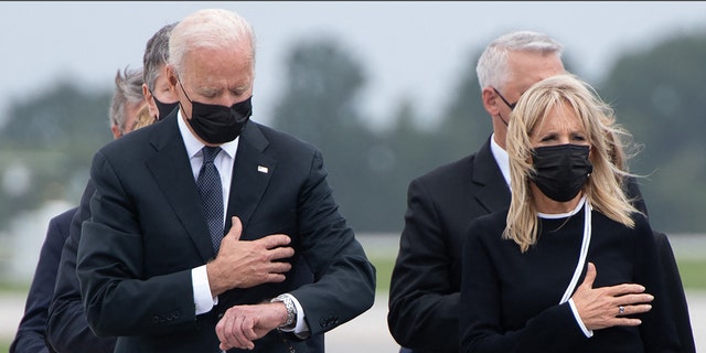 President Joe Biden with First Lady Jill Biden as they attend the dignified transfer of the remains of a fallen service member at Dover Air Force Base.