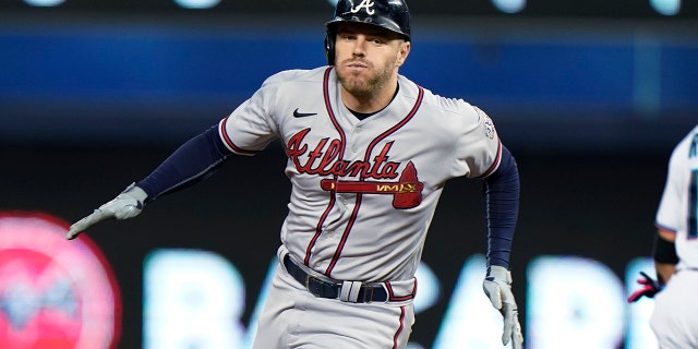 Atlanta Braves' Freddie Freeman rounds second base as he gets a triple during the fourth inning of a baseball game against the Miami Marlins, Wednesday, Aug. 18, 2021, in Miami. (Associated Press)
