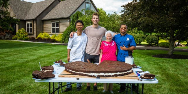 From left to right: Chef Roddy Martin, social media influencers Ross Smith and Gangster Granny and chef Stephen Miller pose with the 180-pound Oreo cookie they baked together in Ohio.