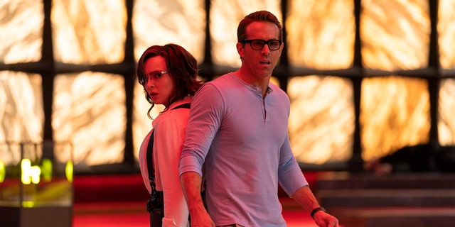 This image released by 20th Century Studios shows Jodie Comer (L) and Ryan Reynolds (R) in a scene from 'Free Guy.'