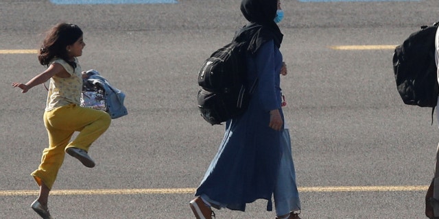 A moving photo of a young Afghan girl skipping on the tarmac of a Belgian airport after being evacuated from her war-torn native country has gone viral.
