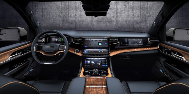 The Grand Wagoneer's interior is trimmed with hectares of wood.