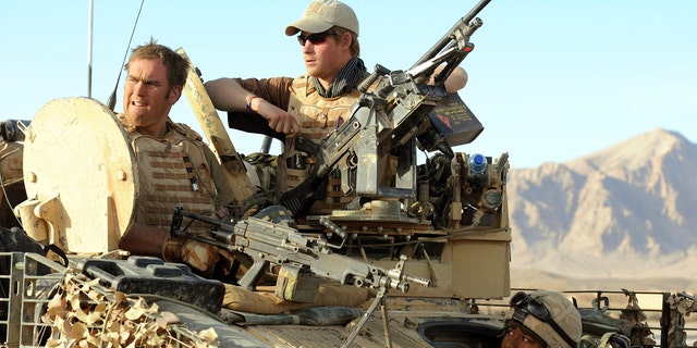 Prince Harry sits with Lance Cpl of Horse Chris 'Dougie' Douglass atop a Spartan armoured vehicle on February 18, 2008 in the Helmand province, Southern Afghanistan.