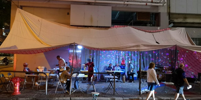 Local people performing Karaoke at a tent on a street in Yau Ma Tei, Kowloon peninsula. Hongkong