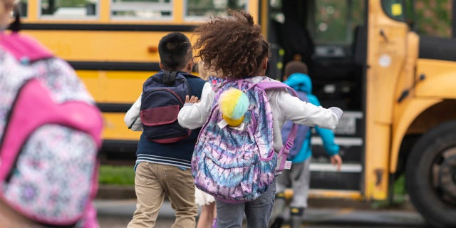 children running onto the school bus