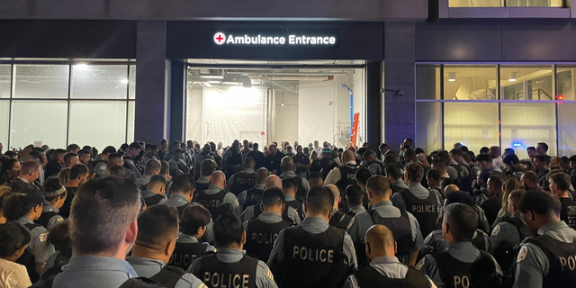 Chicago police officers gather overnight outside the University of Chicago Medical Center, where one officer died and another remained hospitalized after Saturday's shooting incident. (Chicago Police)