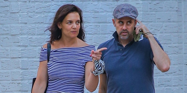 Katie Holmes enjoys conversation during a walk while out to dinner with a friend in New York City.