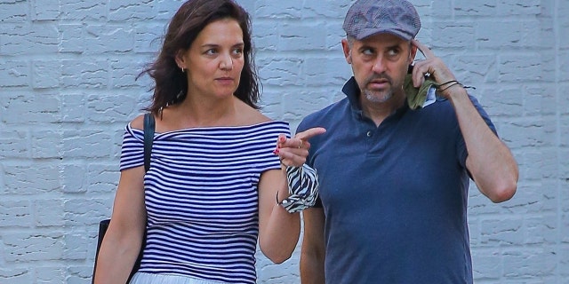 Katie Holmes enjoys conversation during a walk while out to dinner with a friend in New York City.