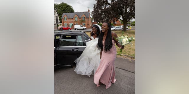 Shenice Beirne (left), her sister Siobahn Ellis (right) and their mother Gloria (back) had to hitchhike to make it to Beirne's wedding ceremony in Gloucester, England. 
