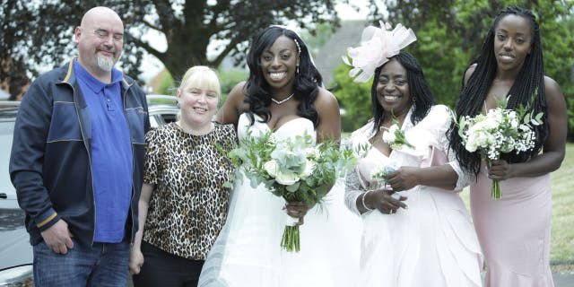 Matt and Michelle Moore (left) volunteered to drive Shenice Beirne and her family to St Barnabas Church. The trio were stranded on a backroad in Gloucester, England after Beirne's rented wedding car broke down.