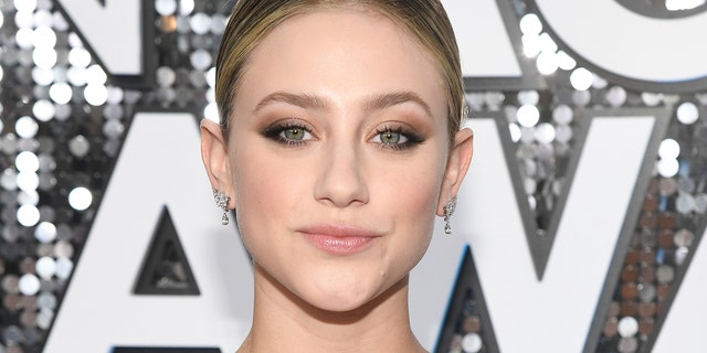 Lili Reinhart posed on a balcony in a brightly colored lime-green bikini.