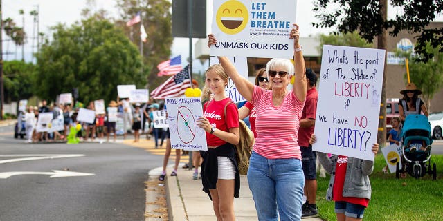 REDONDO BEACH, CA - JULY 27: Let Them Breathe, an anti-mask group, gather to protest at the Redondo Beach Unified School District building on Tuesday, July 27, 2021 in Redondo Beach, CA.(Jason Armond / Los Angeles Times via Getty Images)