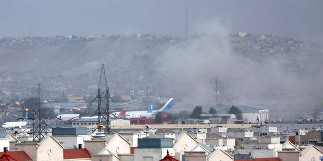 Smoke rises from explosion outside the airport in Kabul, Afghanistan, Thursday, Aug. 26, 2021. The explosion went off outside Kabul’s airport, where thousands of people have flocked as they try to flee the Taliban takeover of Afghanistan. Officials offered no casualty count, but a witness said several people appeared to have been killed or wounded Thursday. 