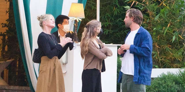 Melanie Griffith is seen leaving dinner as she celebrates her 64th birthday with her youngest daughter Stella Banderas and a male companion.