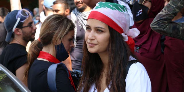 Thousands of people gathered at the site of the blast to pay their respects before marching through the city, calling for the dissolution of parliament and the suspension of laws that protect senior government officials.