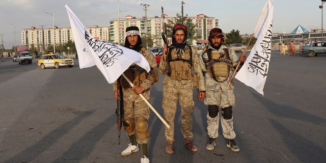 Taliban fighters hold Taliban flags in Kabul, Afghanistan, Monday, Aug. 30, 2021. (AP Photo/Khwaja Tawfiq Sediqi)