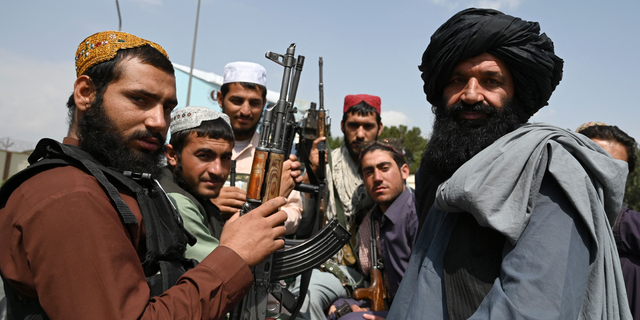 Taliban fighters sit in the back of a van at Kabul airport on August 31, 2021, after the United States withdrew all of its troops from the country to end a brutal 20-year war - one war which started and ended with the die-hard Islamists in power. 