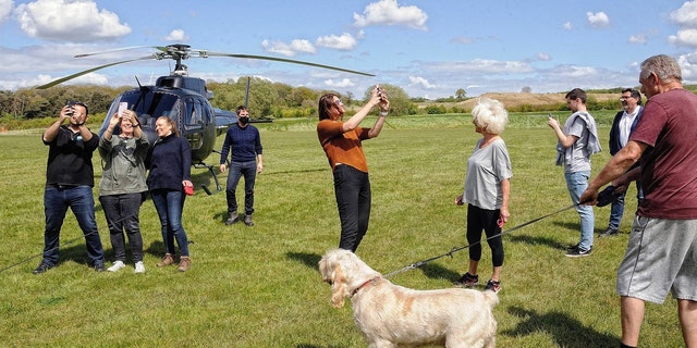 Tom Cruise (center, masked) landed his helicopter in a Warwickshire family's yard because the local airport was closed. 