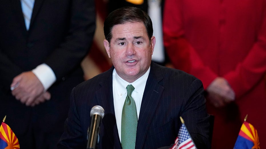 FILE - In this April 15, 2021, file photo, Arizona Republican Gov. Doug Ducey speaks during a bill signing in Phoenix. The Arizona Supreme Court is set to release its decision, Thursday, Aug. 19, 2021, in a constitutional challenge to a new tax on high earners that was designed to increase school funding and approved by the state’s voters in November. Ducey opposed the new tax and said he hopes the state's high court finds it unconstitutional. (AP Photo/Ross D. Franklin, File)