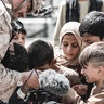 A U.S. Marine assigned to Special Purpose Marine Air-Ground Task Force – Crisis Response – Central Command shows his video camera to children awaiting evacuation at Hamid Karzai International Airport, Afghanistan, Aug. 22, 2021. The U.S. is assisting the Department of State with a Non-Combatant Evacuation Operation (NEO) in Afghanistan. (U.S. Marine Corps photo by Gunnery Sgt. Melissa Marnell)