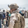 A Marine with Special Purpose Marine Air-Ground Task Force-Crisis Response-Central Command (SPMAGTF-CR-CC) provides assistance during an evacuation at Hamid Karzai International Airport, Kabul, Afghanistan, Aug. 22. U.S. service members are assisting the Department of State with an orderly drawdown of designated personnel in Afghanistan. (U.S. Marine Corps photo by Sgt. Samuel Ruiz).