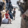 A child waits with her family to board a U.S. Air Force Boeing C-17 Globemaster III during an evacuation at Hamid Karzai International Airport, Kabul, Afghanistan, Aug. 22. U.S. service members are assisting the Department of State with an orderly drawdown of designated personnel in Afghanistan. (U.S. Marine Corps photo by Sgt. Samuel Ruiz).